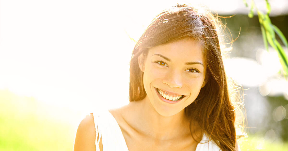young-white-woman-smiling-at-camera Young white woman smiling at camera