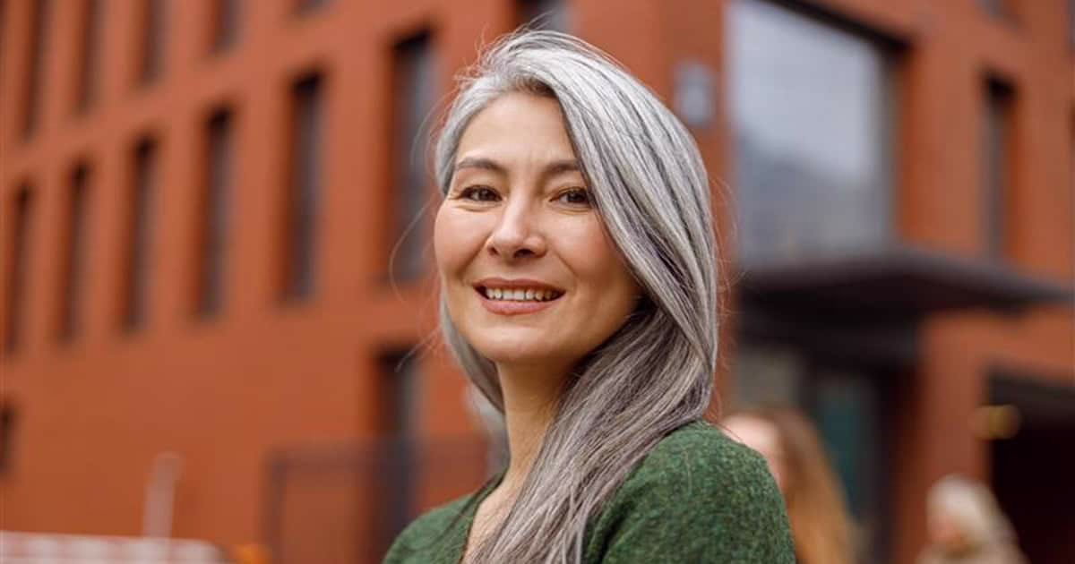 confident woman in her 50s looking at camera Confident young woman looking at camera