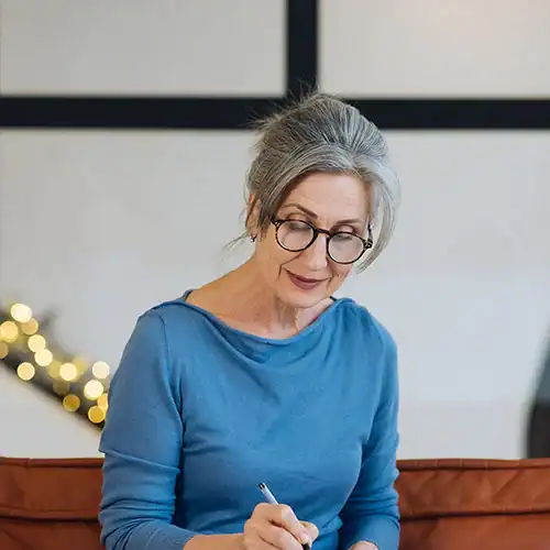 woman writing notes in a journal