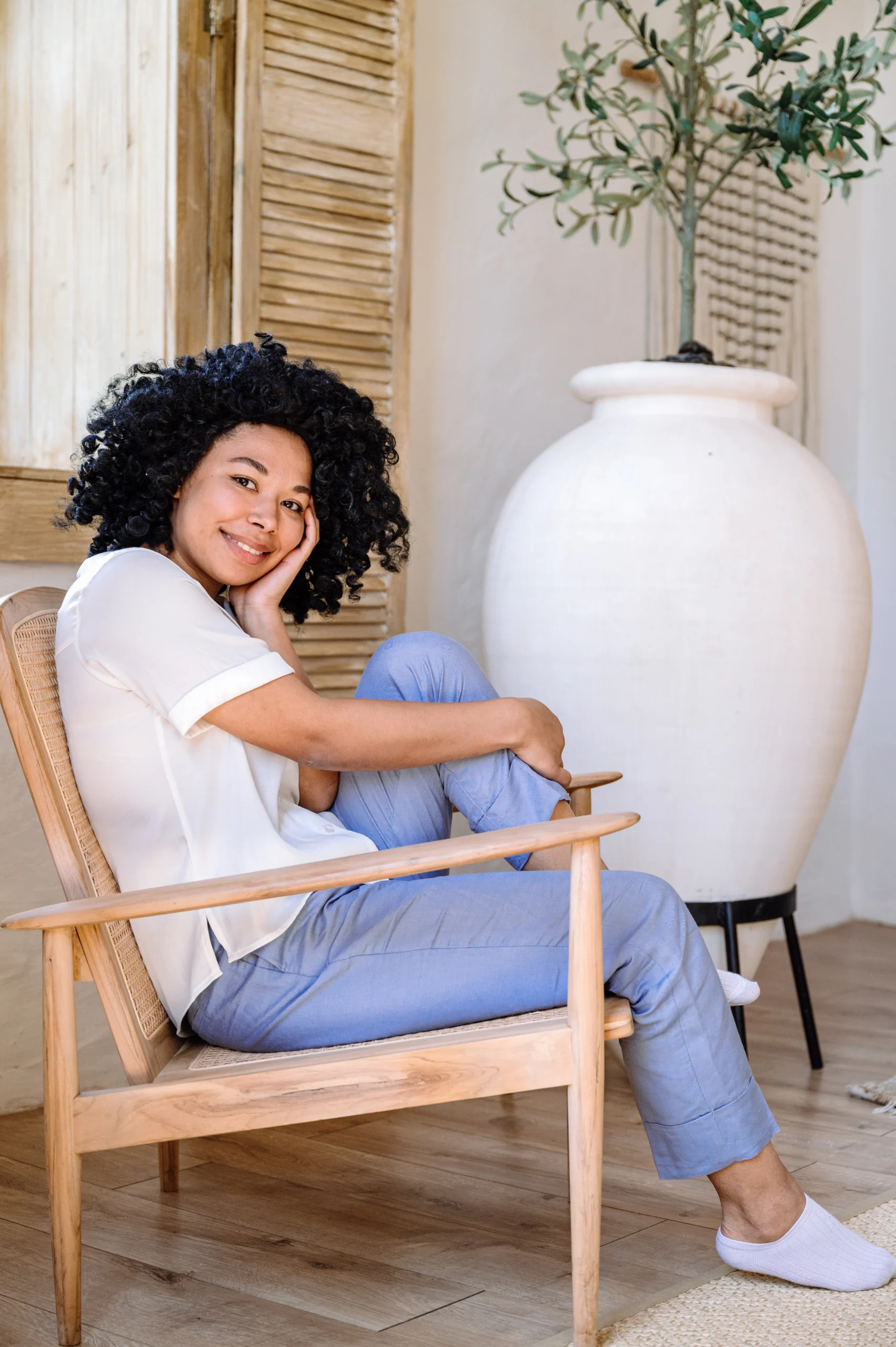Happy,Carefree,African,American,Woman,Sitting,On,Armchair,Hug,Her Peaceful reflective woman outdoors